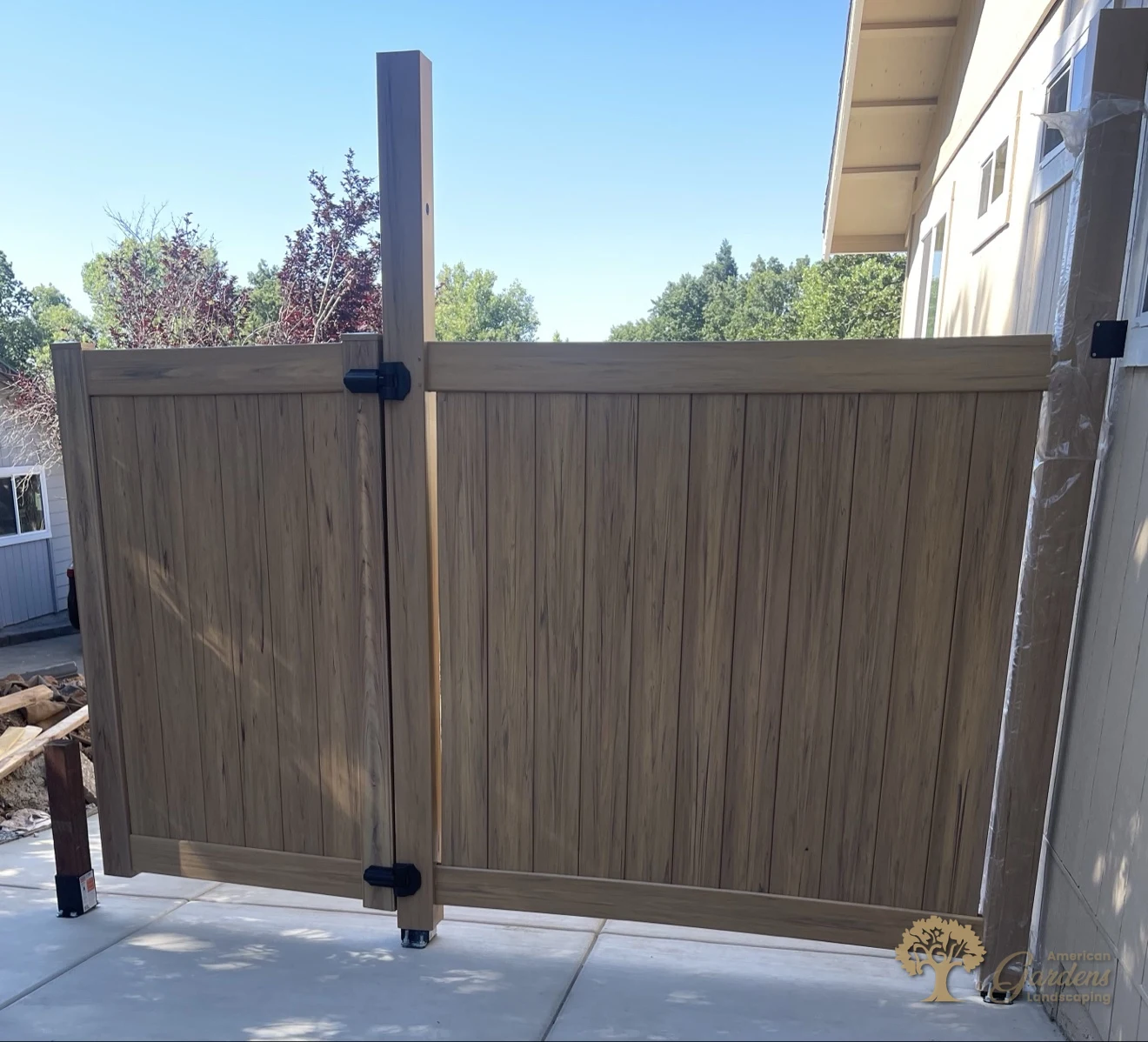 New wood-grain vinyl privacy fence and gate in Cameron Park