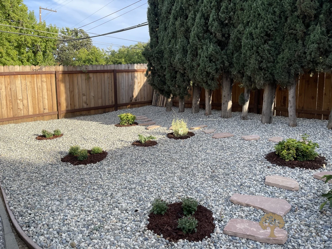 Carmichael Backyard Landscaping – Finished Gravel Yard with Flagstone Stepping Stones – American Gardens Landscaping