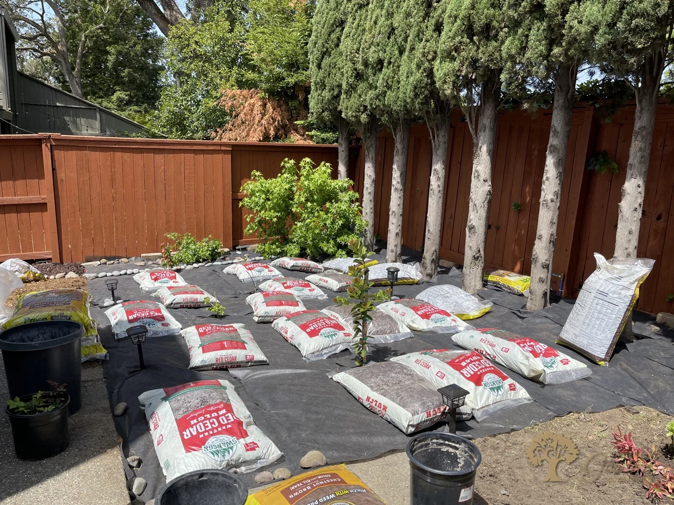 Citrus Heights Backyard Landscaping – Mulch Bags Staged on Weed Fabric – American Gardens Landscaping