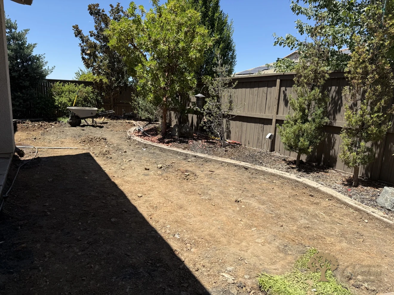 Freshly graded backyard with the old lawn and soil removed, ready for new retaining walls in a Serrano backyard in El Dorado Hills, by American Gardens Landscaping.