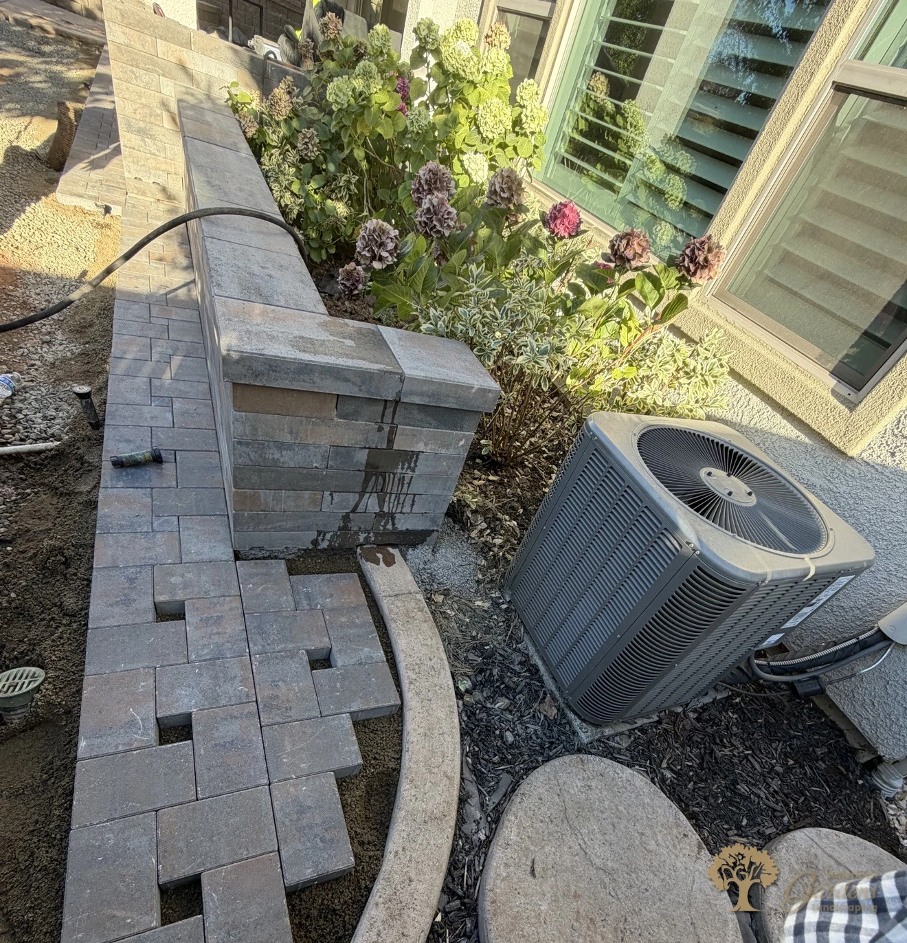 Paver walkway carefully cut and fitted around the AC unit and stepping stones in El Dorado Hills, by American Gardens Landscaping.