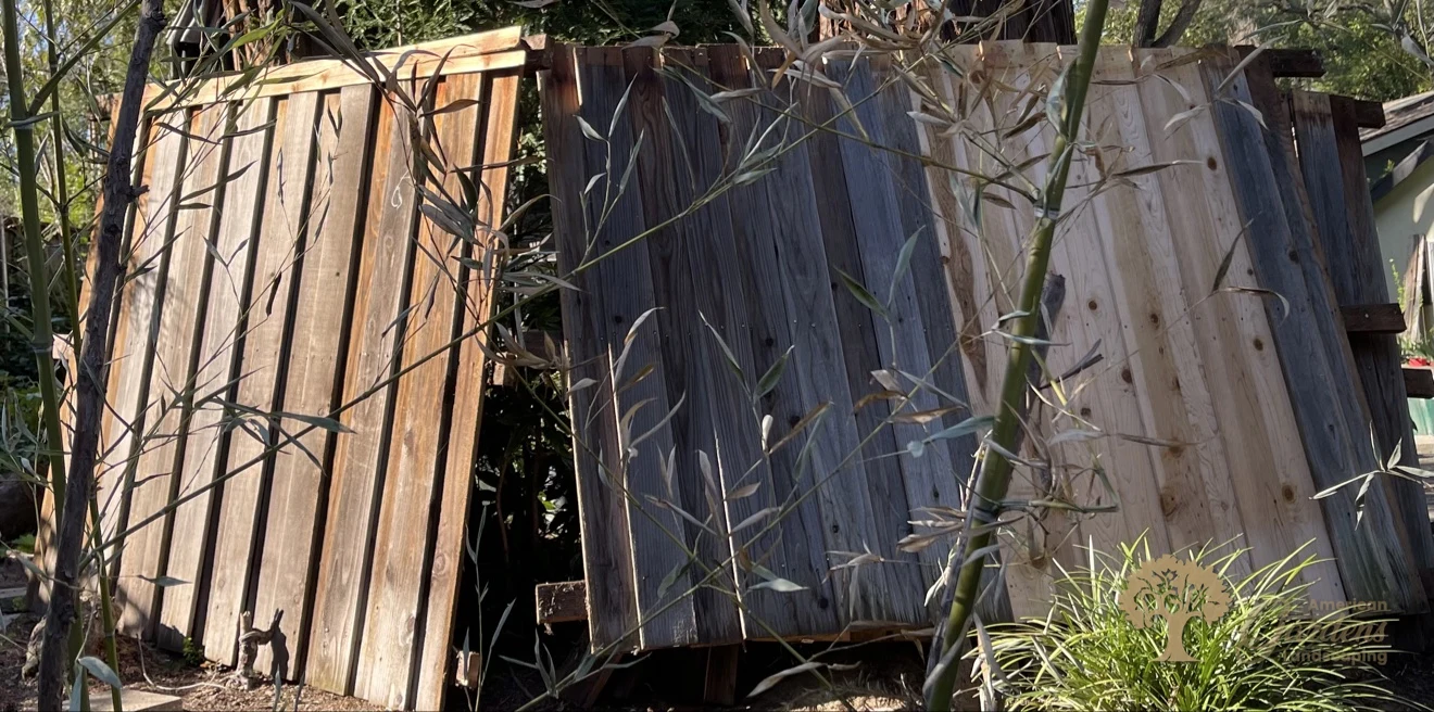 Damaged wooden fence panels being removed and replaced during a fence repair in Fair Oaks