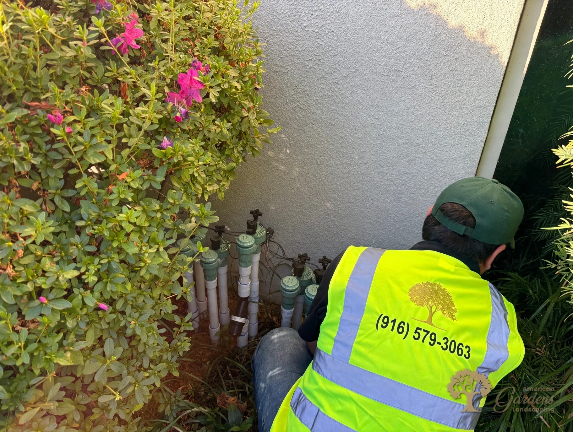 Technician checking an irrigation valve manifold in Fair Oaks