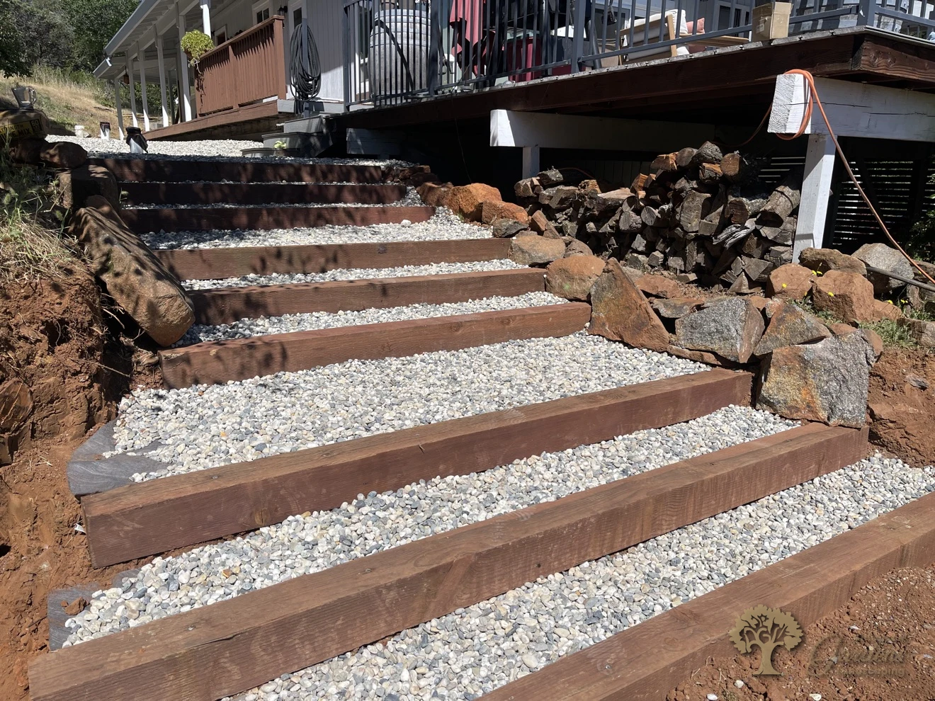Finished pressure-treated wood steps with gravel treads on a Shingle Springs hillside – American Gardens Landscaping