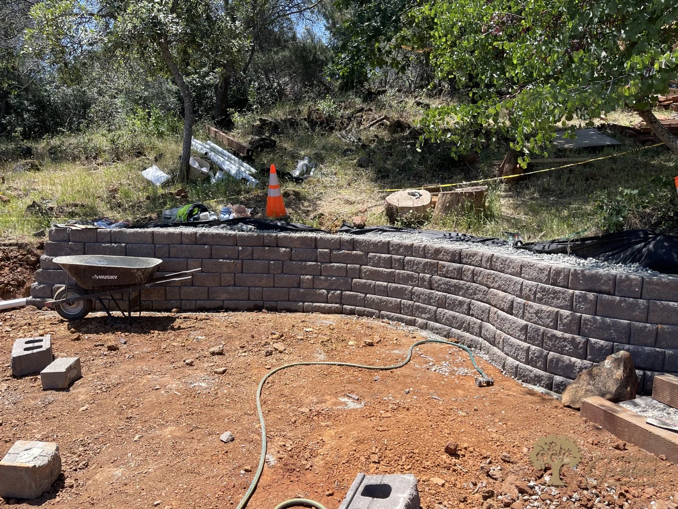Finished curved segmental block retaining wall on a hillside in Shingle Springs