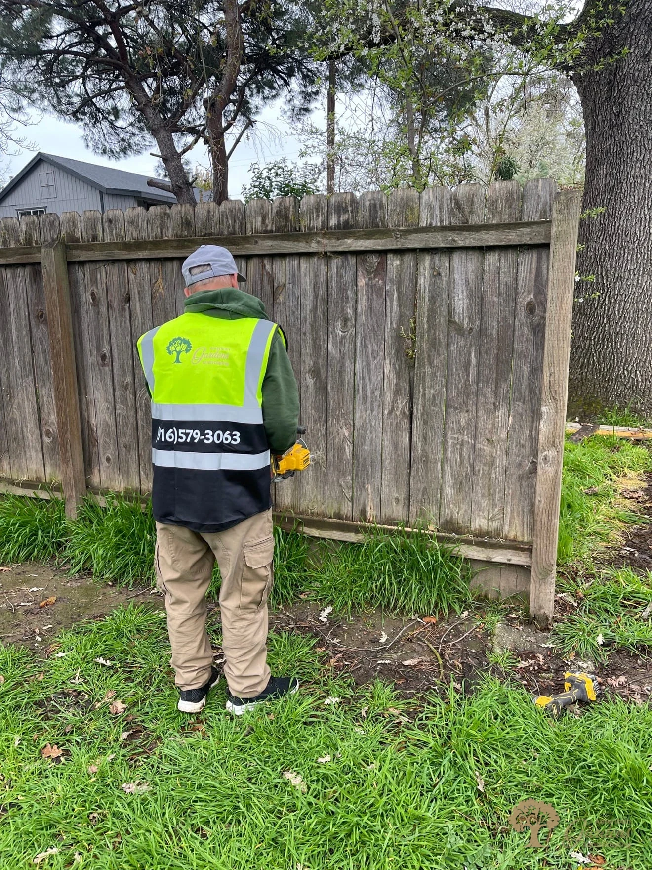 American Gardens Landscaping worker during demolition of an old fence before installing a replacement fence in Sacramento