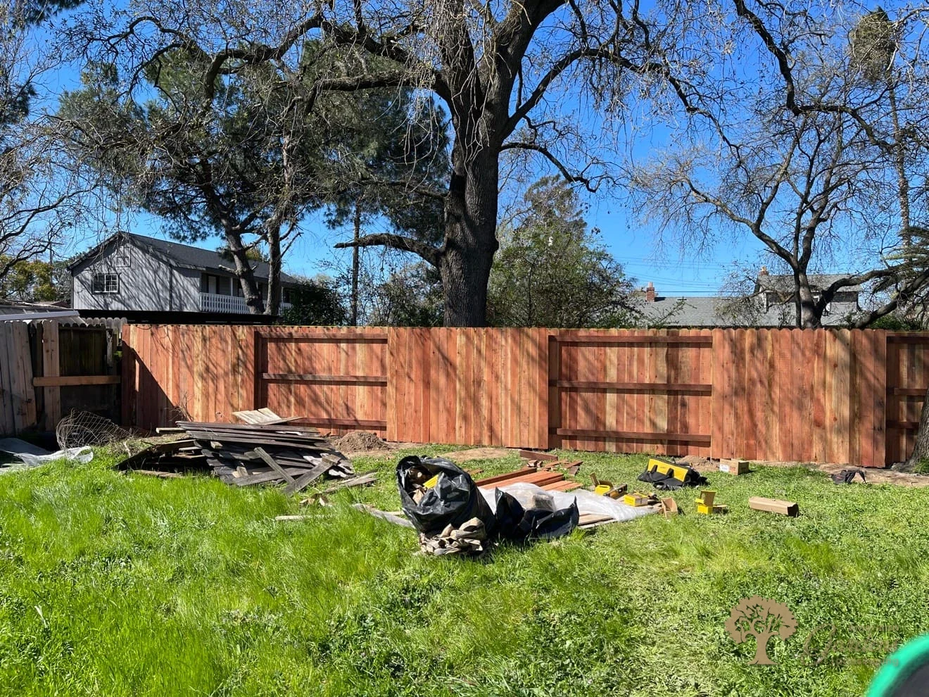 New custom redwood fence in a backyard installed by American Gardens Landscaping in Fair Oaks