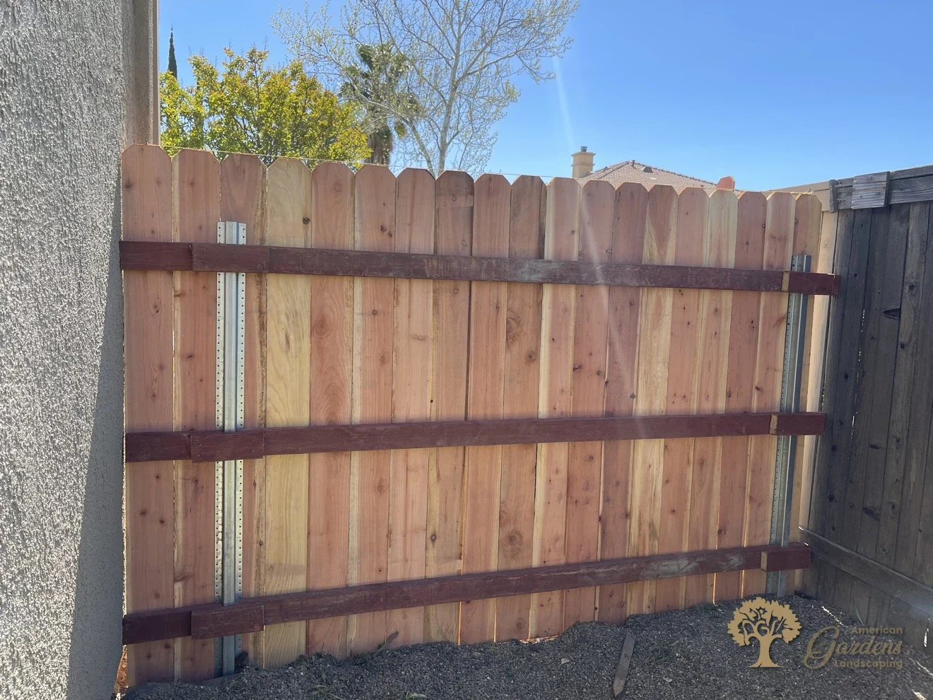Finished run of a redwood dog-ear fence on galvanized steel posts with three rails, built in Roseville by American Gardens Landscaping