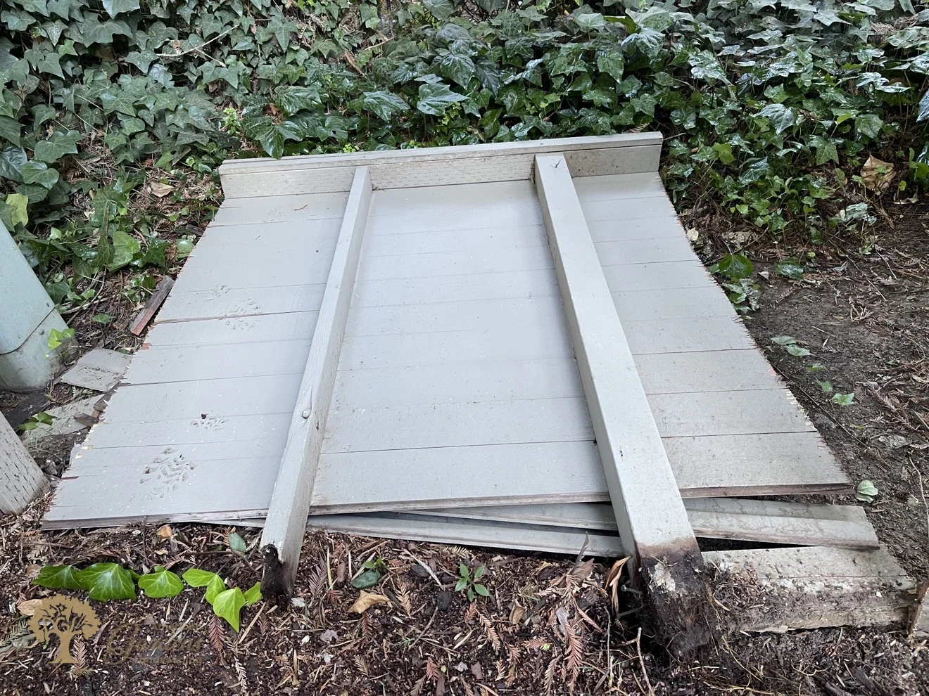 A removed fence panel lying on the ground in Sacramento with its rotted post bottoms clearly visible, showing why the old fence failed, by American Gardens Landscaping
