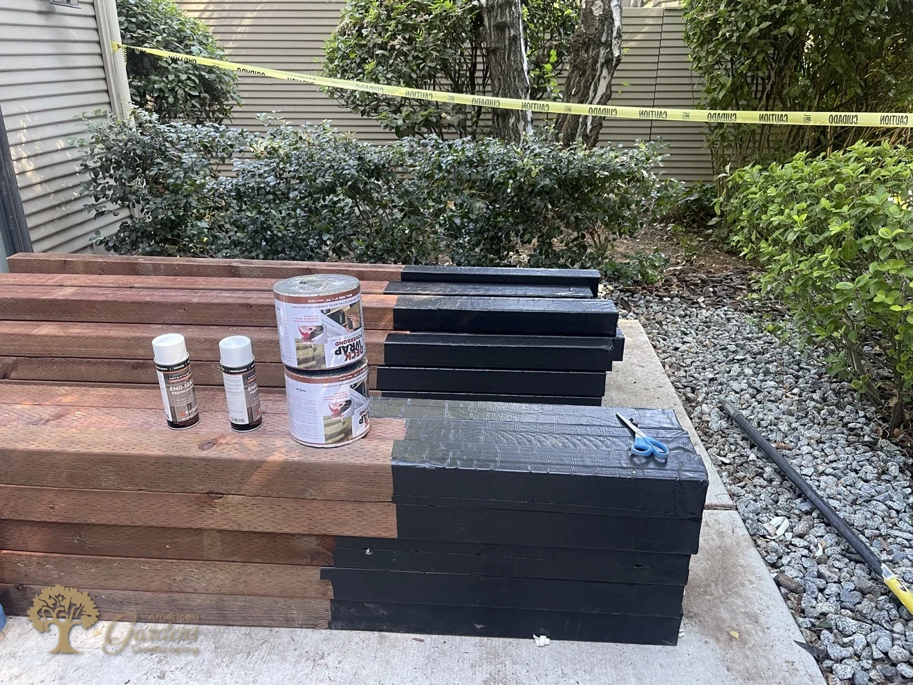 Fence posts wrapped in waterproof membrane before installation – American Gardens Landscaping