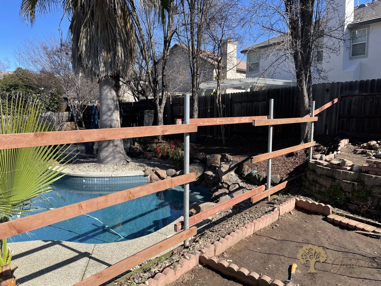 Steel posts and pressure-treated rails with Simpson brackets for a redwood fence in Folsom – American Gardens Landscaping