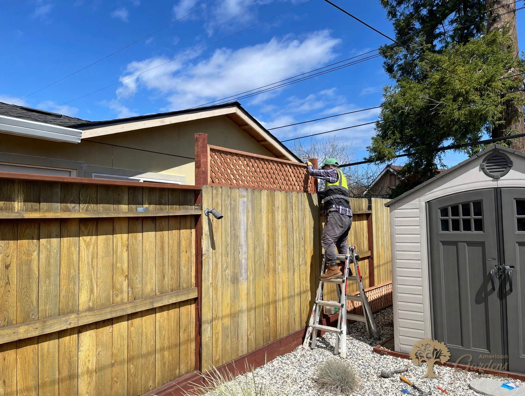Installing a redwood lattice panel on top of an existing fence in Rancho Cordova – American Gardens Landscaping