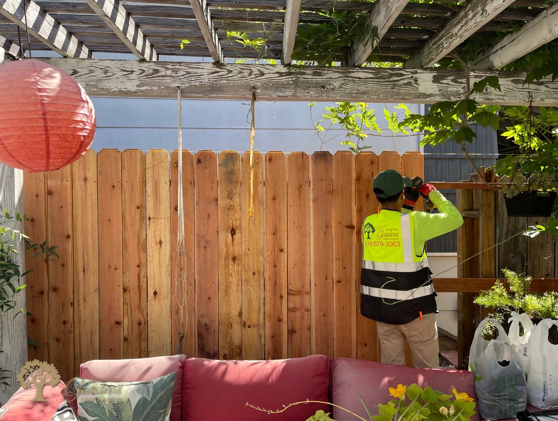 Screwing redwood pickets in place with Simpson connectors in Sacramento – American Gardens Landscaping