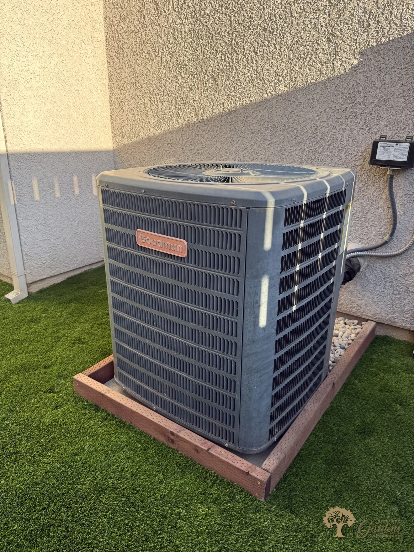 AC unit on its new wood-framed base surrounded by artificial turf in Rocklin – American Gardens Landscaping