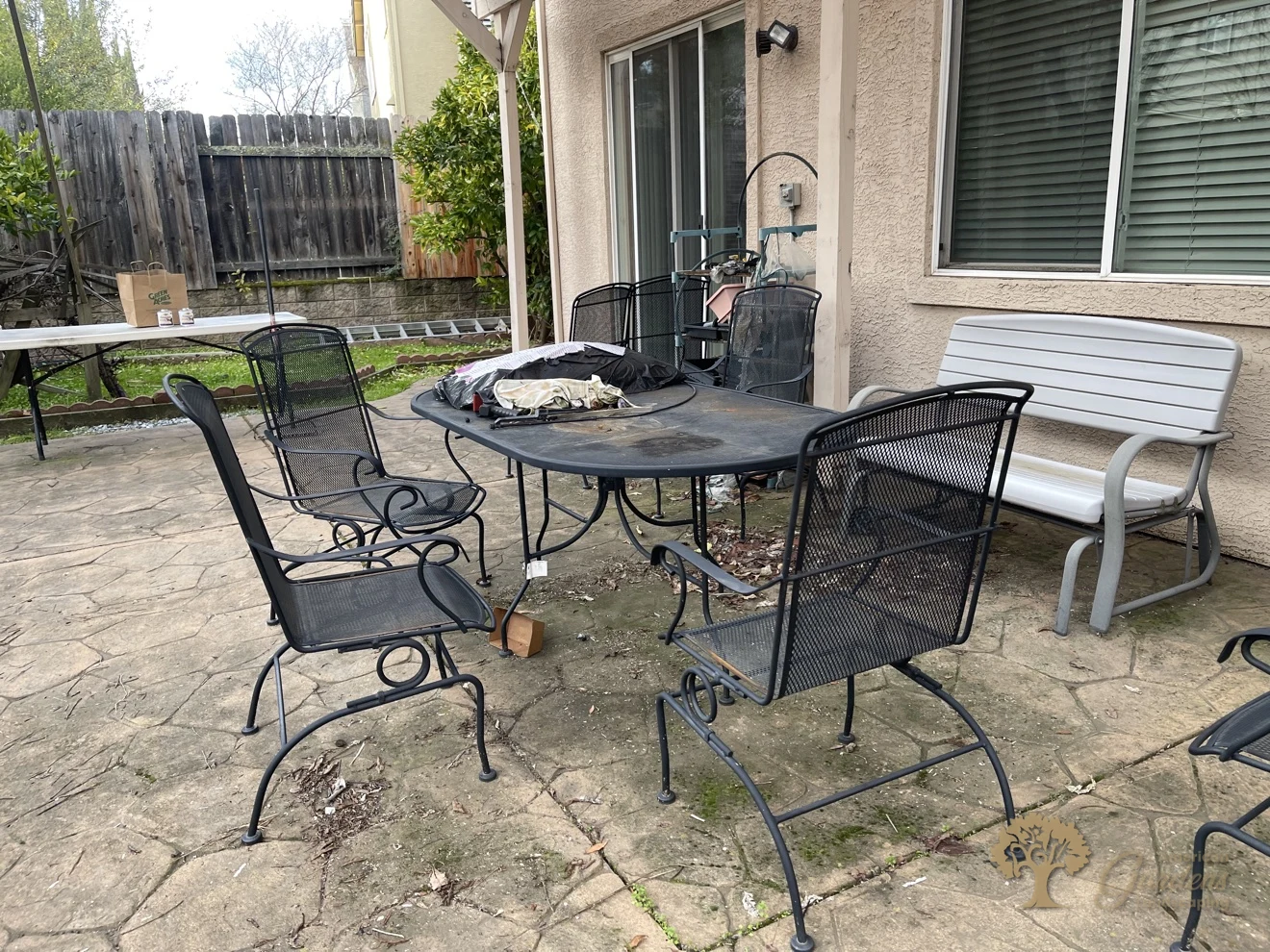 Worn stamped-concrete patio before the backyard makeover in Folsom – American Gardens Landscaping