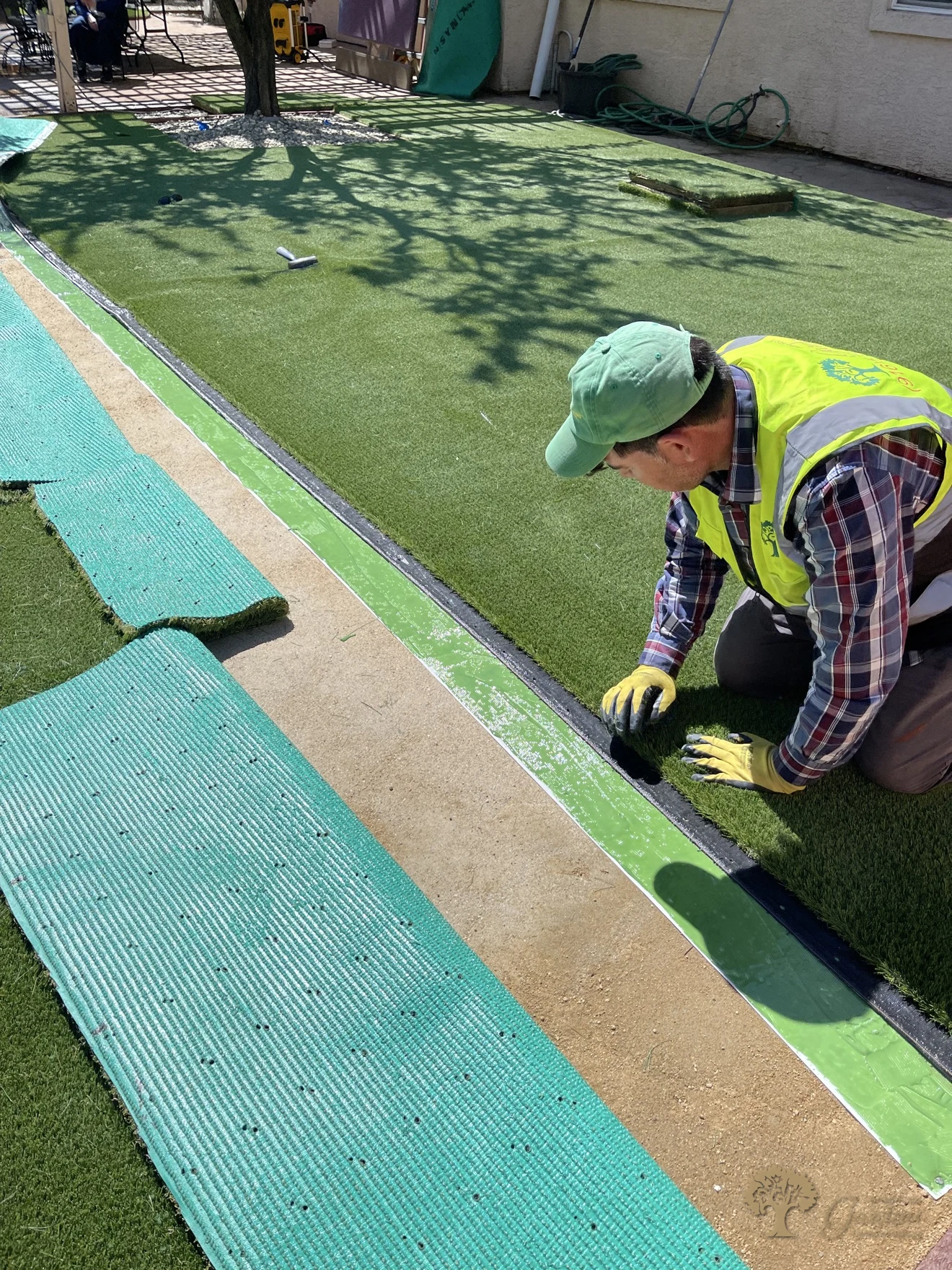 Pressing the turf seam for an invisible join in Folsom – American Gardens Landscaping
