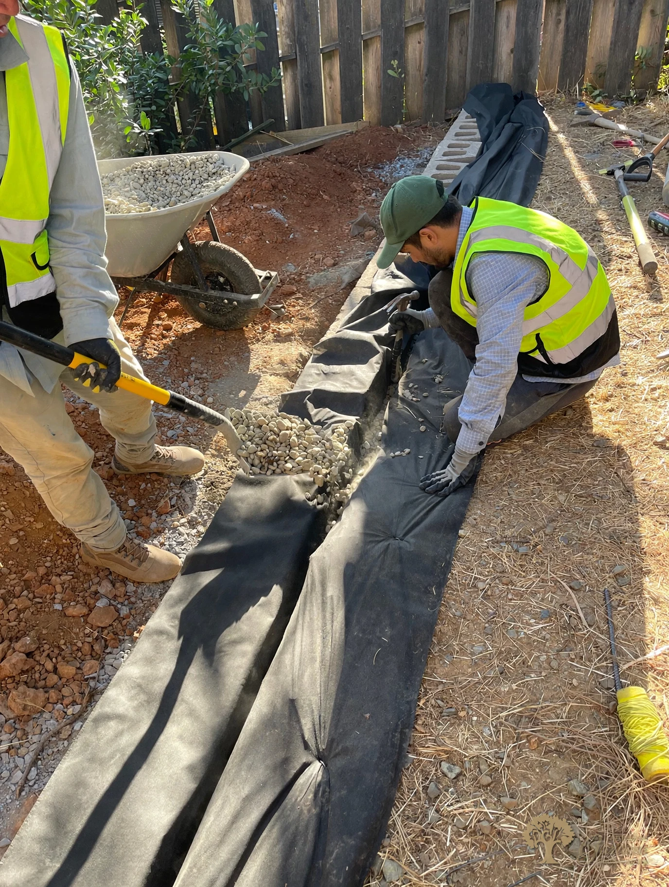 Drainage fabric and river rock behind the retaining wall in Shingle Springs – American Gardens Landscaping