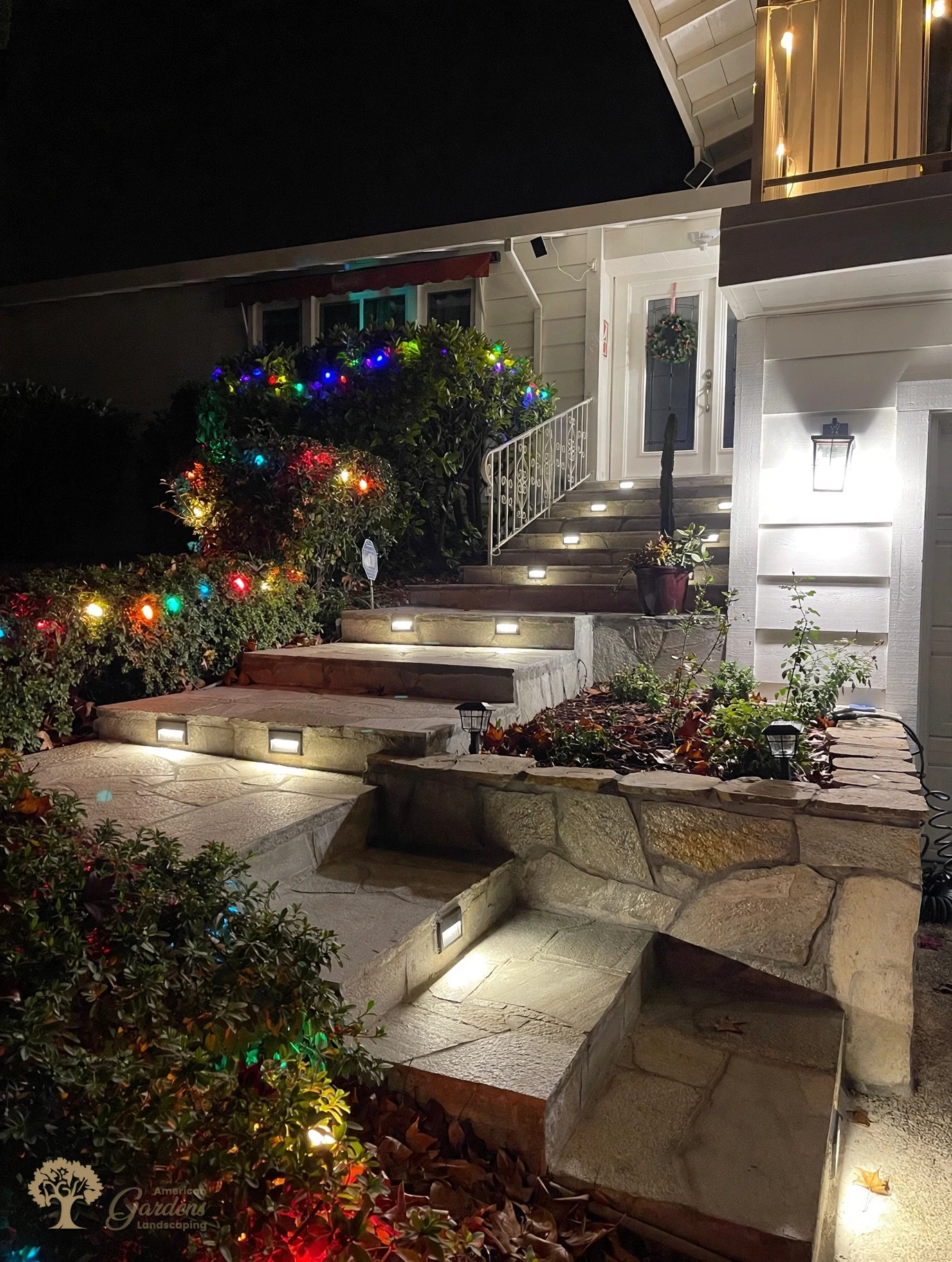 Flagstone entry steps with built-in step lighting at night in Fair Oaks – American Gardens Landscaping