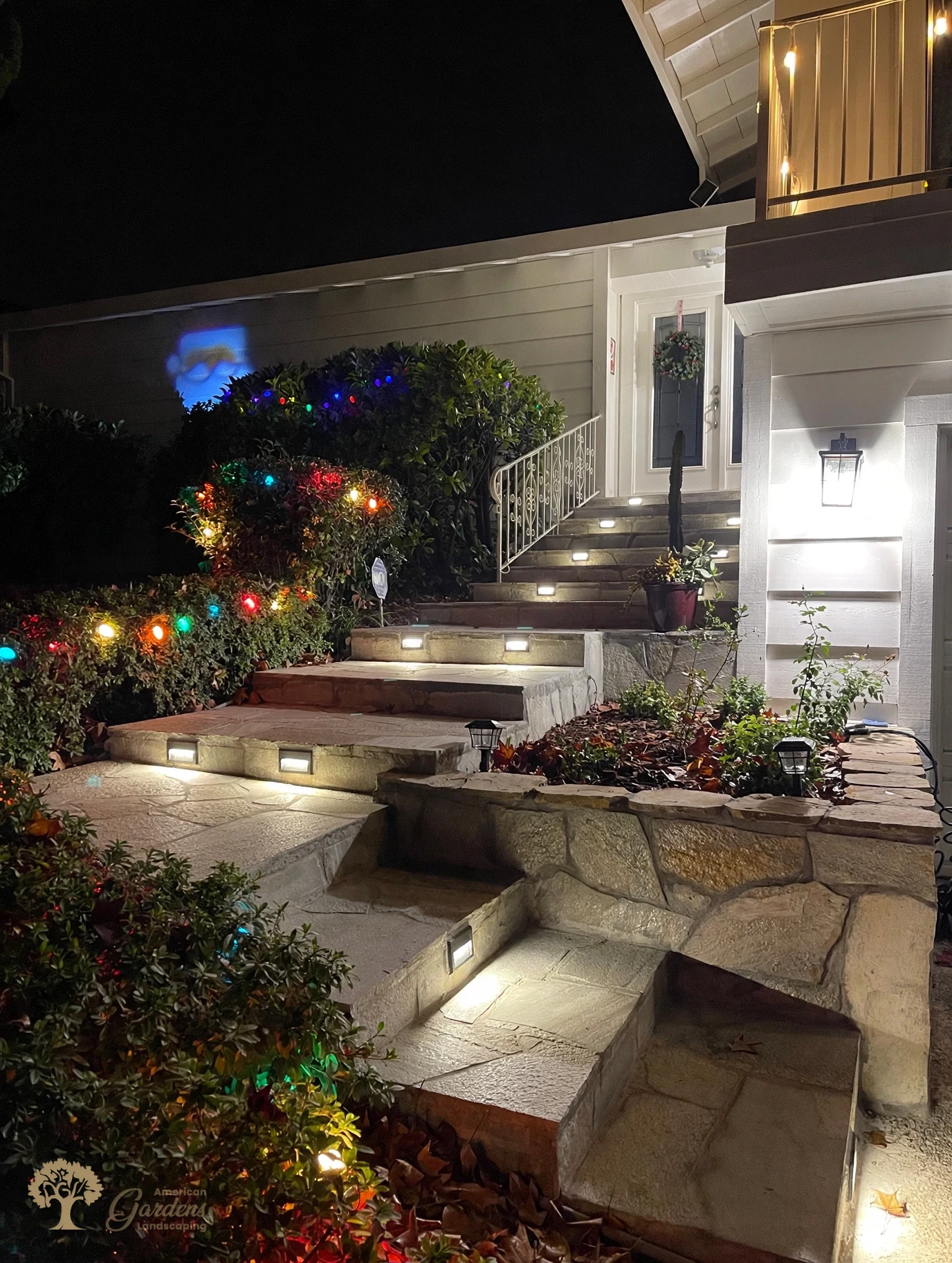 Natural stone steps and retaining wall with landscape lighting in Fair Oaks – American Gardens Landscaping