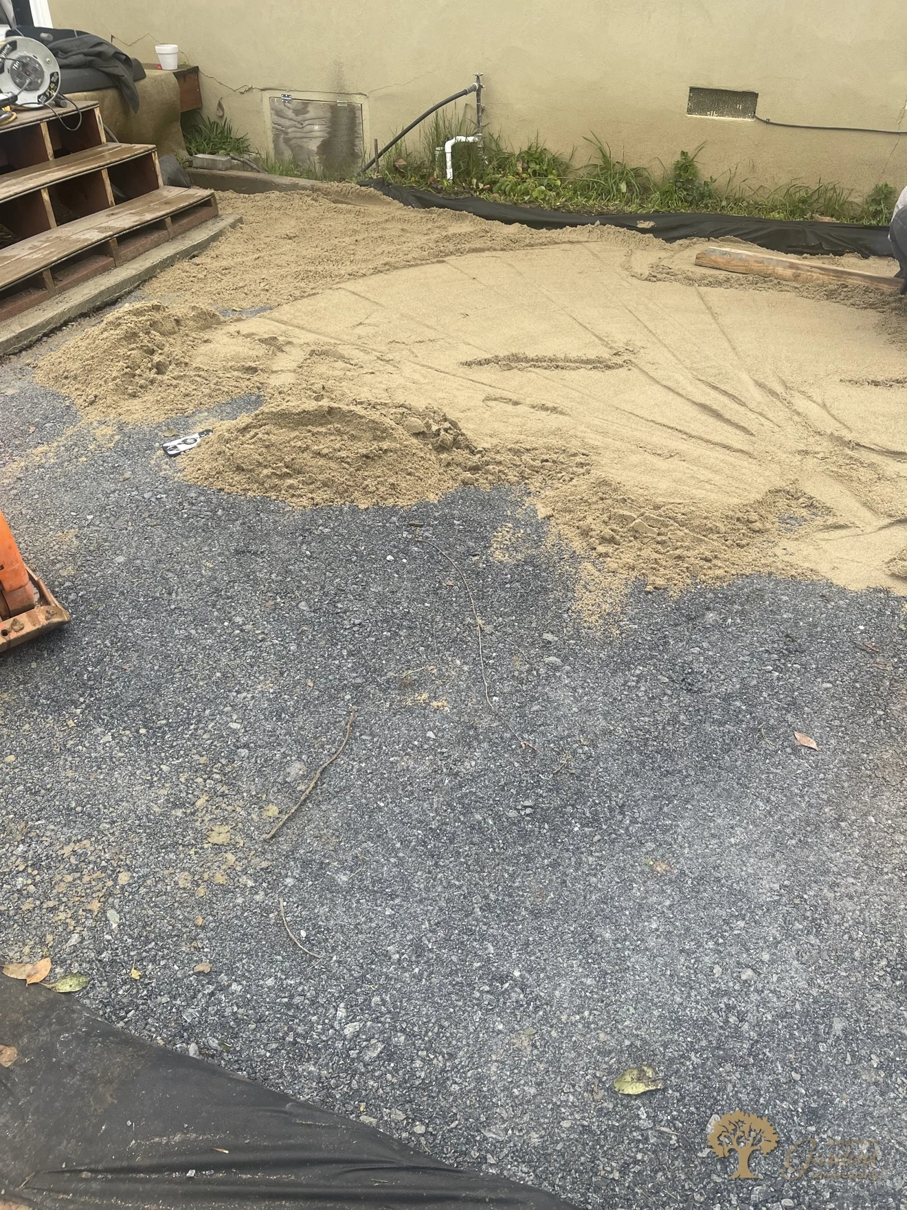 Bedding sand spread over base rock for a herringbone paver patio in Sacramento – American Gardens Landscaping