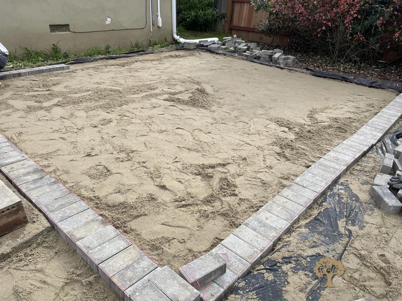 Border pavers and screeded bedding sand for a herringbone paver patio in Sacramento – American Gardens Landscaping