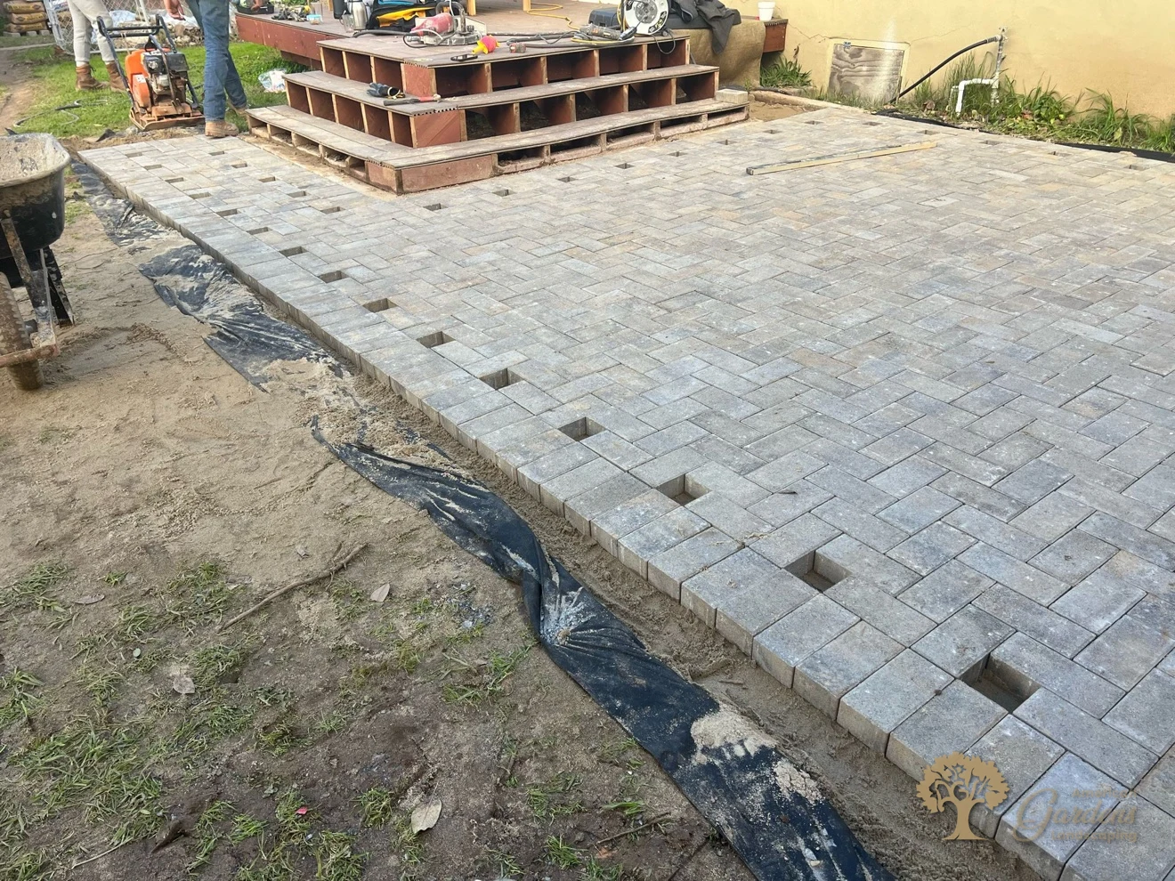 Herringbone paver field being laid inside its border for a herringbone paver patio in Sacramento – American Gardens Landscaping