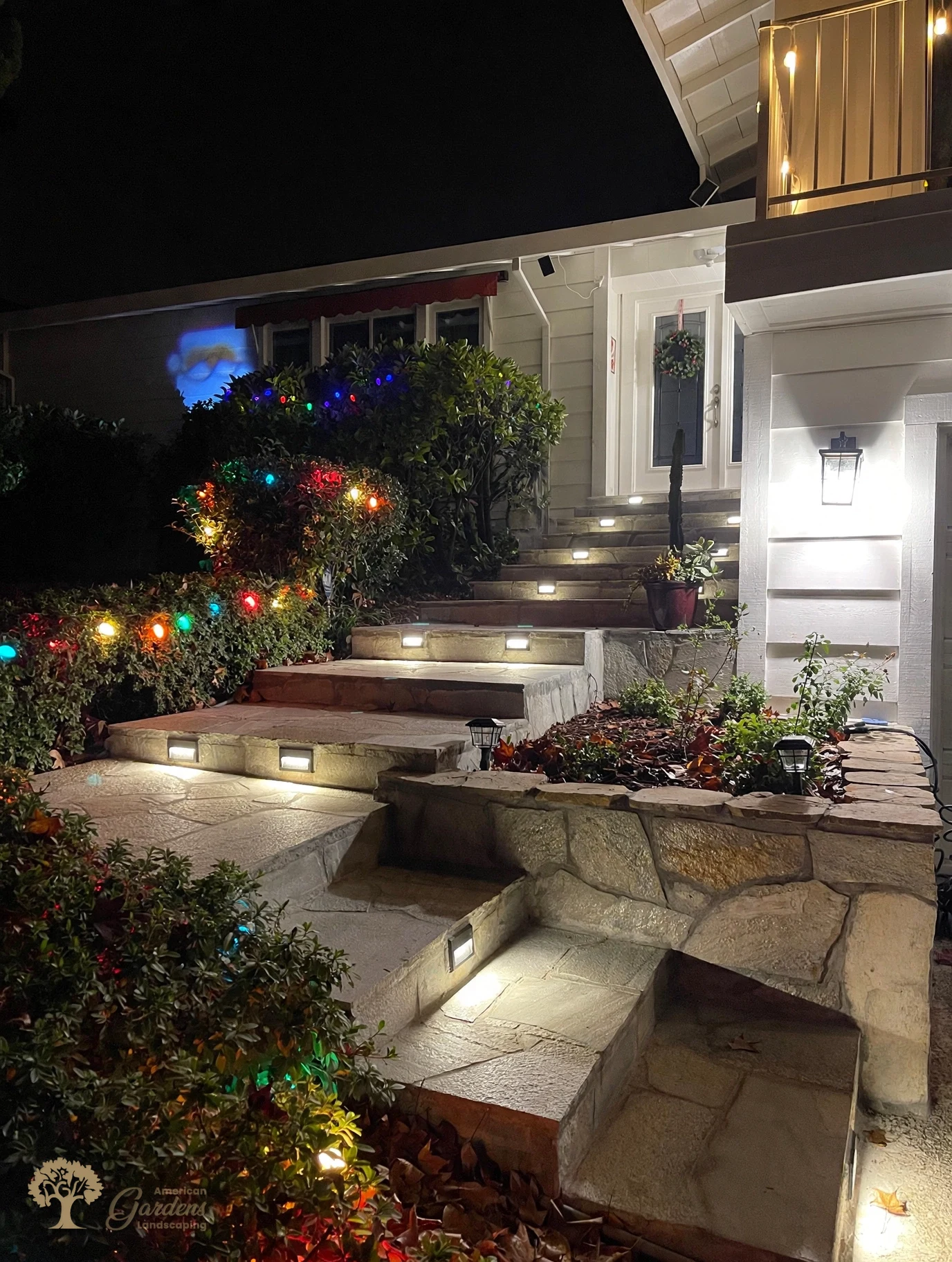 Outdoor step lights illuminating a stone entryway in Fair Oaks – American Gardens Landscaping