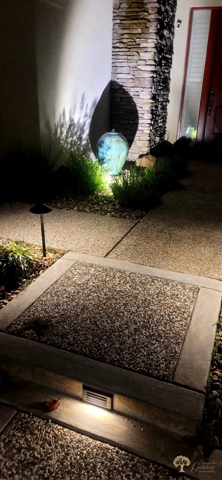 Landscape lighting with an illuminated urn fountain in Roseville – American Gardens Landscaping