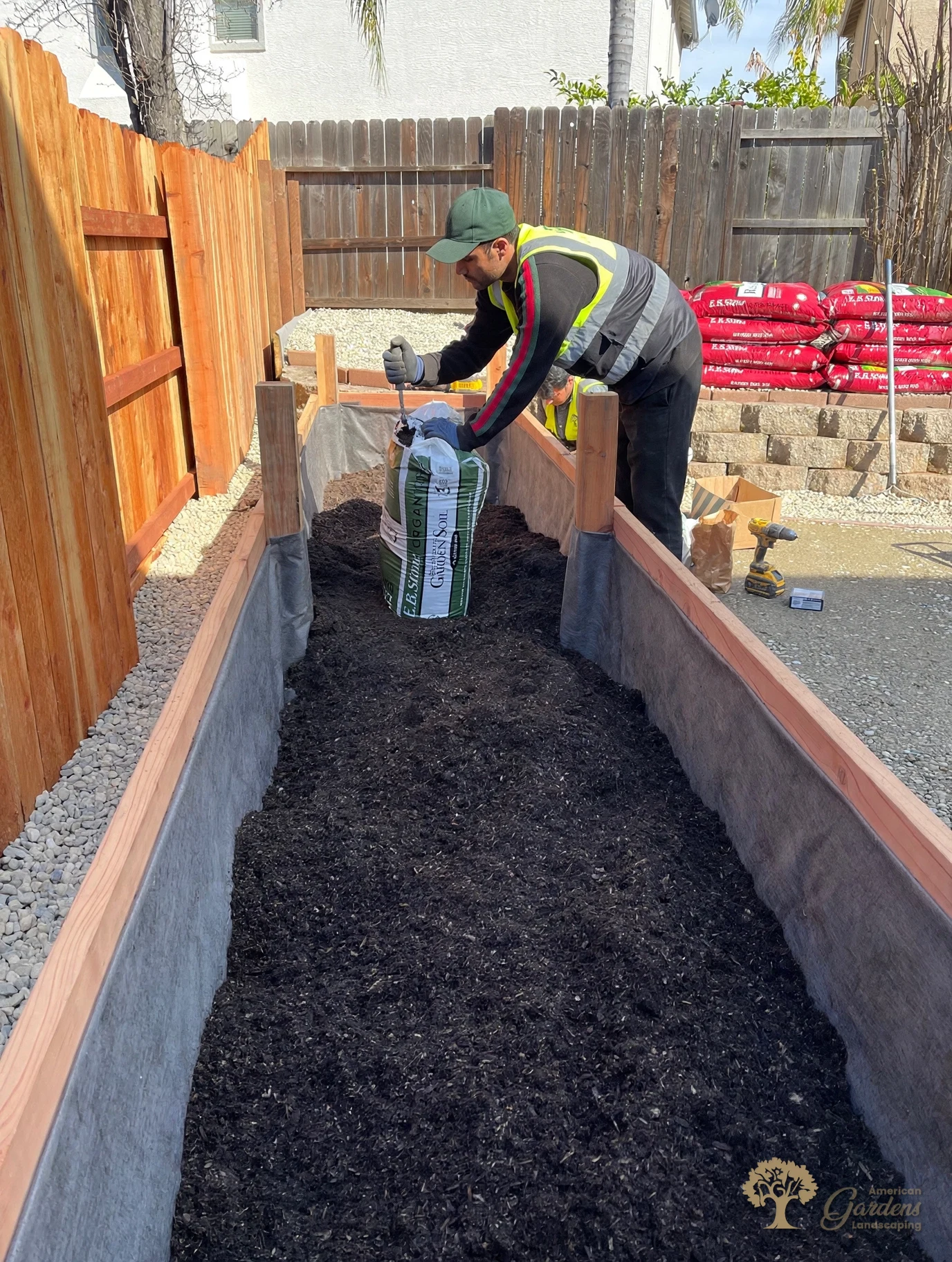 Filling the redwood raised bed with organic garden soil in Folsom – American Gardens Landscaping
