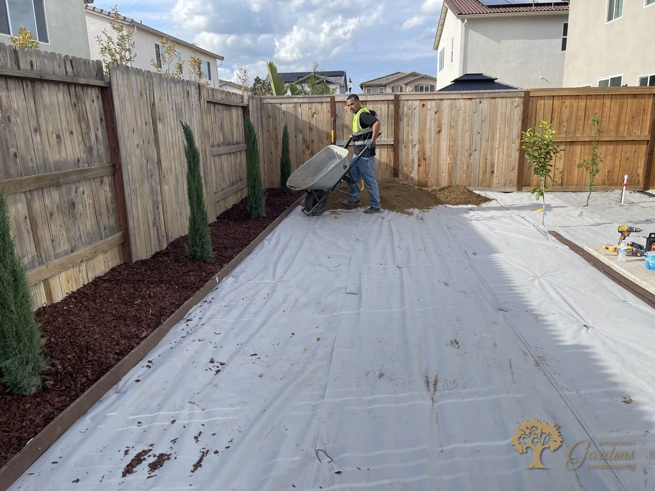 Spreading decomposed granite over the fabric in Lincoln – American Gardens Landscaping