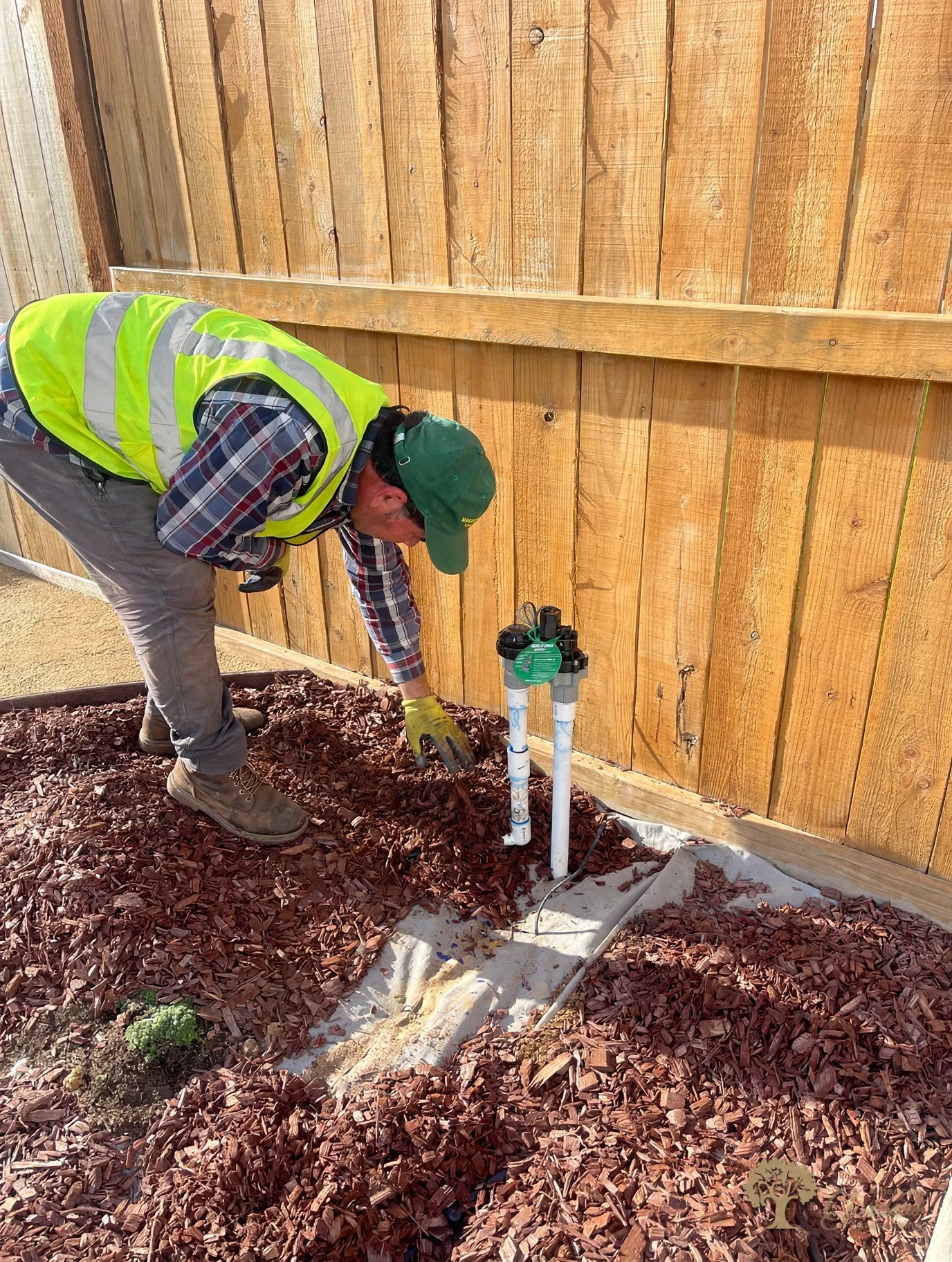 Installing irrigation valves by the fence in Lincoln – American Gardens Landscaping